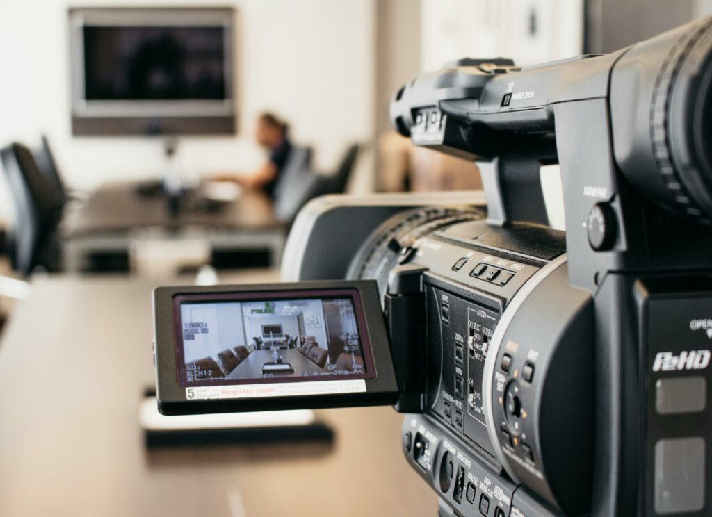pexels photo 17486300 17486300 Close-up of professional video camera recording in modern office environment.